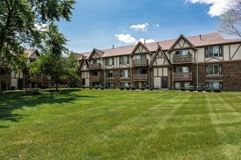 an apartment building with a large yard in front of it at Polo Run Apartments, Indiana